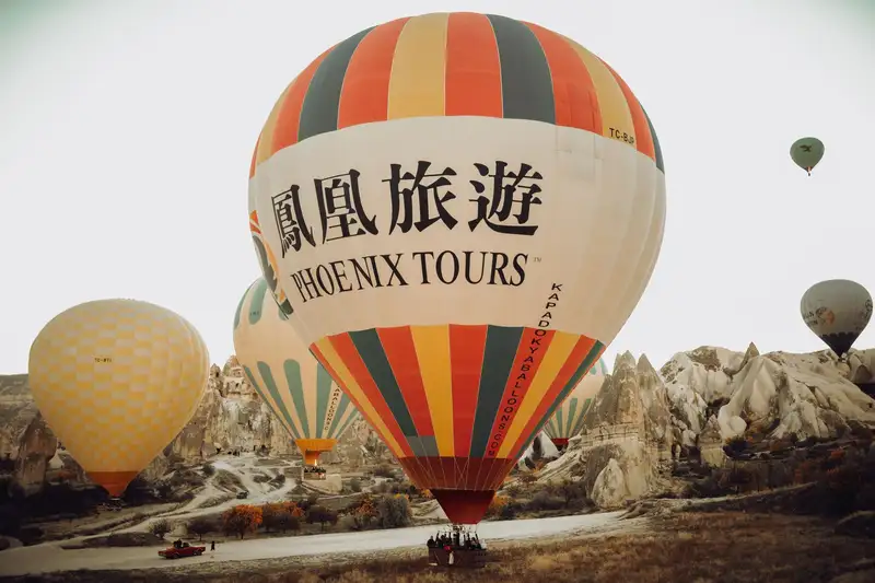 Spectacular hot air balloons soaring over Cappadocia's unique landscape at sunrise.